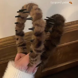 Close-up of plush leopard print hair claw clip with black inner teeth for secure grip