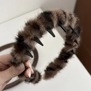 Detail of leopard print plush headband featuring internal anti-slip comb teeth design