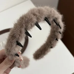 Close-up of soft taupe plush headband featuring non-slip inner teeth and fuzzy texture