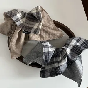 Detail of dual-sided plaid and waffle texture hair scrunchie with a handmade woven label