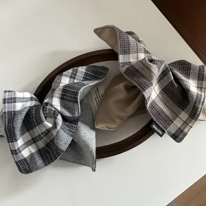 Close-up of British plaid hair scrunchie set with waffle fabric and Hand Made label