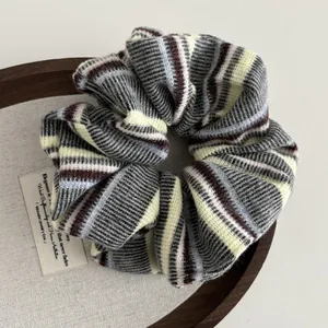 Knitted stripe scrunchie in dark grey, beige, and burgundy colors for hair styling