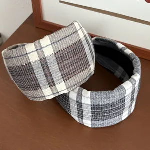 Detail of vintage thick plaid headbands in brown houndstooth and grey windowpane fabric