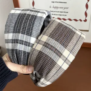 Detail of plaid headband featuring thick brushed fabric texture and retro checkered patterns