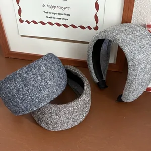 Close-up of wide knitted sponge headbands showing fabric texture in three colors