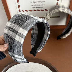 Detail showing the thick plaid texture and grey checkered fabric of these retro headbands