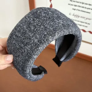 Detail of grey knitted wide headband showing chunky wool texture and thick sponge padded style
