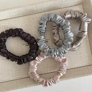 Set of four satin scrunchies with rhinestones in coffee, silver, champagne, and pink