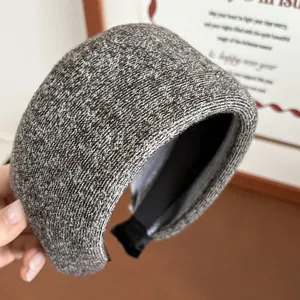 Close-up of wide knitted headband in grey with black non-slip inner lining detail
