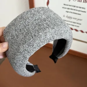 Detailed close-up of grey knitted headband with thick sponge padding for high head crown