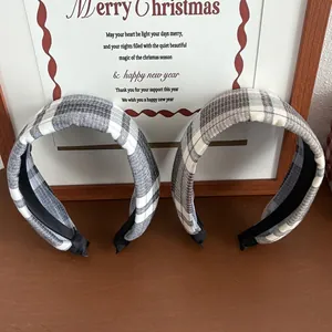 Padded plaid headbands in grey and beige tones on a festive wooden background