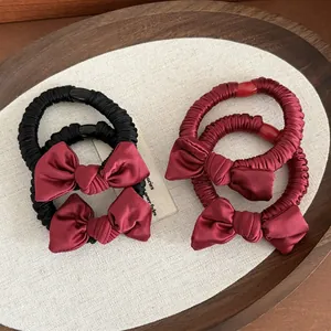 Elegant satin bow scrunchie set in burgundy and black with elastic pleated band
