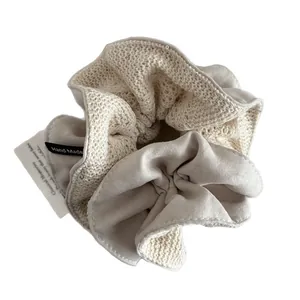 Elegant knit hollow scrunchie with beige fabric patchwork and subtle sequins