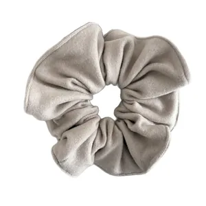 Elegant oversized plush fabric scrunchie in light grey with soft quilted wool texture