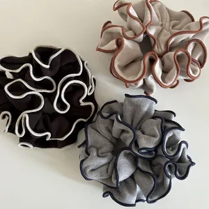 Three premium wool-feel oversized ruffled scrunchies with contrast edging on white background