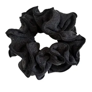 Dark grey wool texture scrunchie with detailed stitching on white background