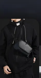 Detail of waterproof men's crossbody bag with magnetic buckle and high-quality leather texture