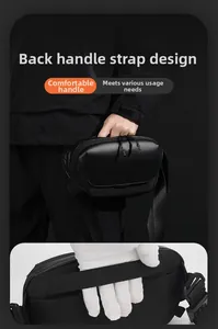 Detail of the reinforced back webbing handle for comfortable hand-carry on the black bag