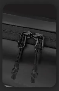 Detail of waterproof crossbody bag featuring dual smooth zippers and woven pull cords