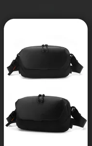 Close-up of waterproof matte fabric and dual-zipper system on a black tactical crossbody bag