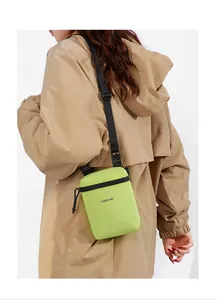 Neon green lightweight sports crossbody bag with adjustable strap worn by model