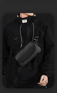 Close-up of matte waterproof fabric and magnetic buckle on the black men's chest bag