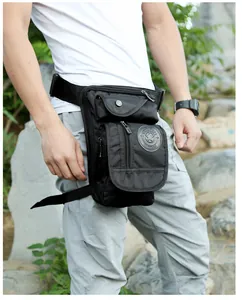 Detail view of durable black nylon tactical drop leg bag with multi-zippered compartments