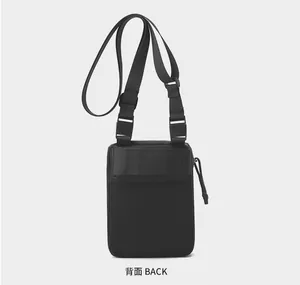 Detailed back view of a minimalist black nylon crossbody sports bag with adjustable strap