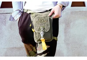 Detail of army green nylon tactical leg bag with metallic safety hook and HS logo