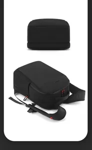 Close-up of black minimalist commuter backpack with breathable straps and red zipper detail