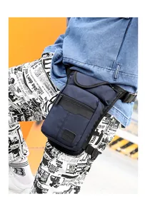 Detail of dark blue waterproof tactical leg bag with adjustable straps and zipper pockets