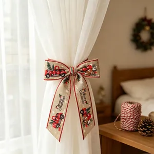 Christmas bow decoration with red truck and festive tree on a white curtain