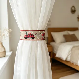 Detail of Christmas curtain tieback with Merry Christmas print and festive truck pattern