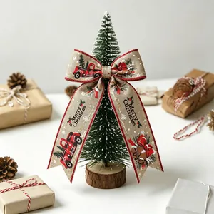 Close-up of decorative Christmas bow with Merry Christmas print on a mini tabletop tree