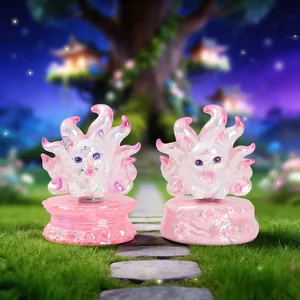 Close-up of two translucent pink nine-tailed fox figurines on lotus and floral bases