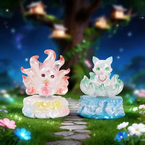 Detailed view of two resin fox figurines with translucent bases in a fantasy forest setting