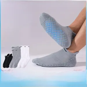 Detail view of anti-slip silicone dots on the sole of thick cotton sports socks