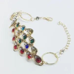 Macro shot of peacock bracelet with colorful rhinestones on a gold plated finish