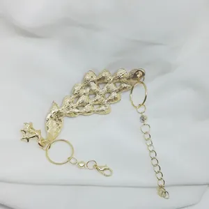 Detail view of gold-plated peacock bracelet showing lobster clasp and extension chain
