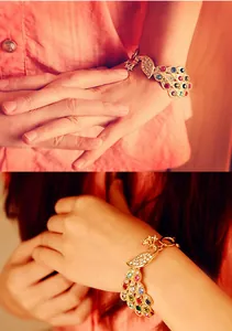 Close-up of colorful peacock bracelet with rhinestones worn on a model's wrist