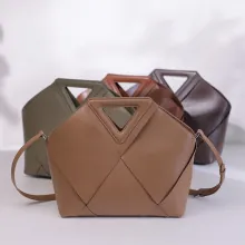 Premium leather tote bags with geometric design and triangle handles in multiple colors