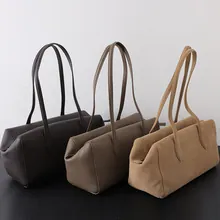 Close-up of three genuine leather tote bags in brown, taupe and tan