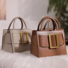 Vintage leather tote bags featuring large metal buckles in brown and beige tones