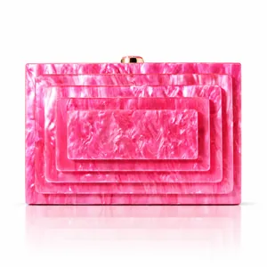 Detail view of hot pink marbled acrylic clutch bag featuring layered rectangular design