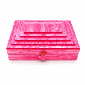 Pink marble pattern acrylic evening bag with stepped layered design and gold clasp