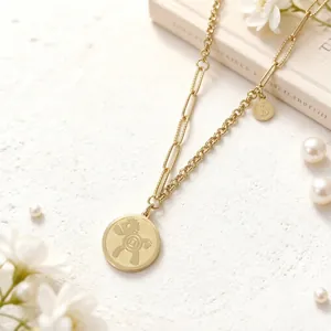 Detail of gold-plated titanium necklace featuring a cute pony pendant and currency charms