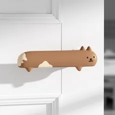Detail view of a cat-shaped brown silicone door handle cover for child safety protection
