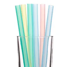 Close-up of colorful food-grade silicone straws in a glass for toddler drinking cups
