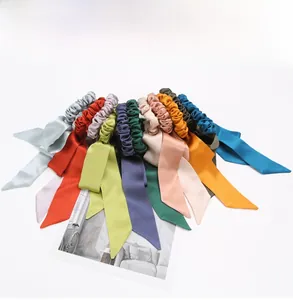 Detail view of colorful silk bow hair scrunchies with long ribbons in vibrant colors