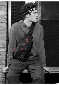 Close-up of waterproof nylon sling bag featuring orange zipper details and durable fabric